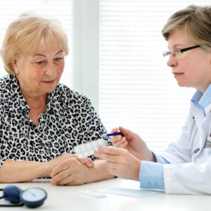 Doctor and senior patient discussing medication.