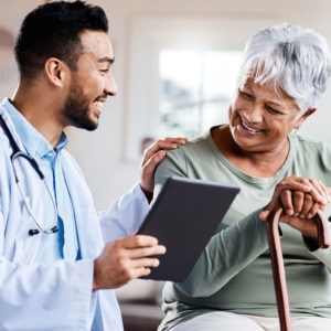 Shot of a young doctor sharing information from his digital tablet with an older patient